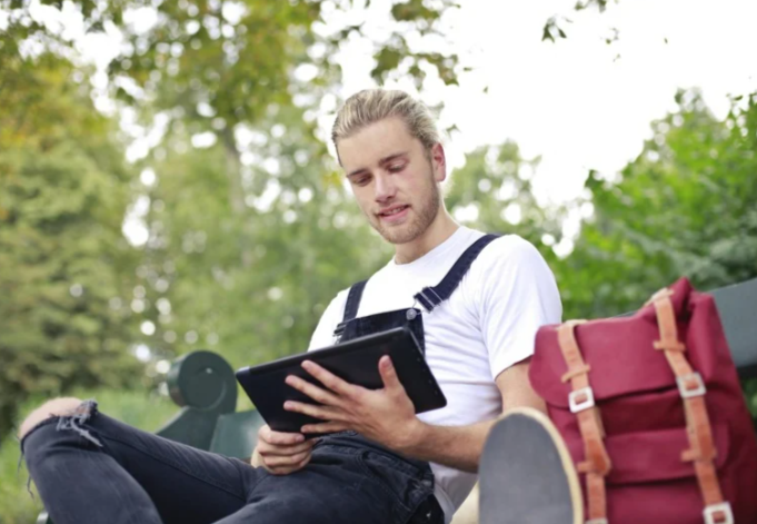 Man Tablet reading scripture